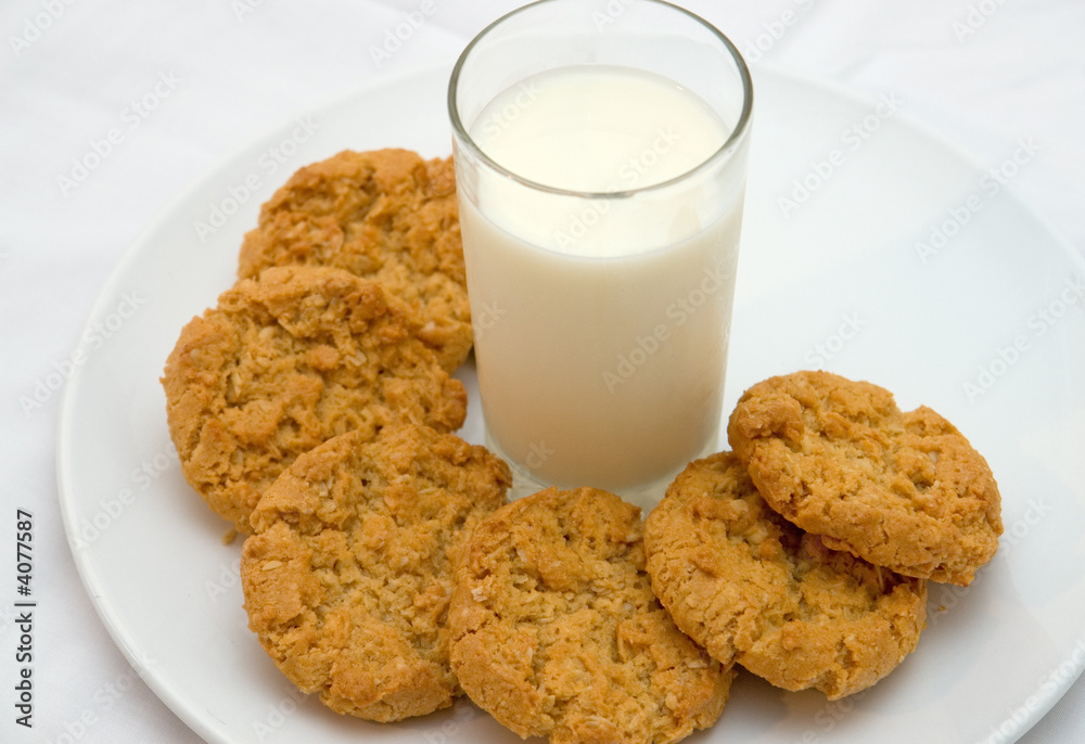 plate of cookies and glass of milk on isolated white plate plate of cookies and glass of milk on isolated white plate