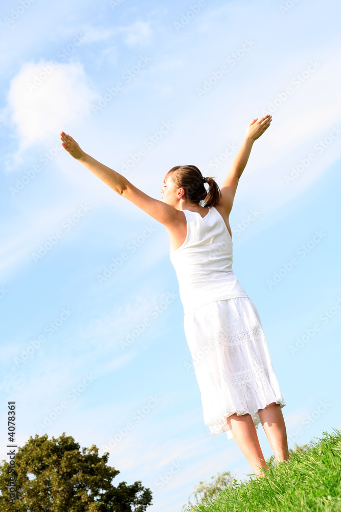 Woman spreading arms to sky