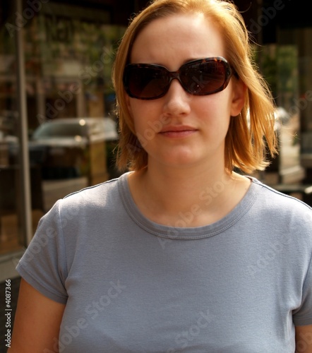 Woman walking through a street, mid-morning shopping