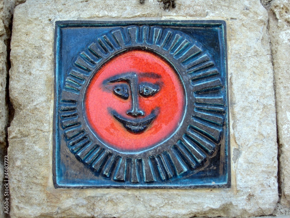 detail of a stone sun figure on wall detail of a stone sun figure on wall