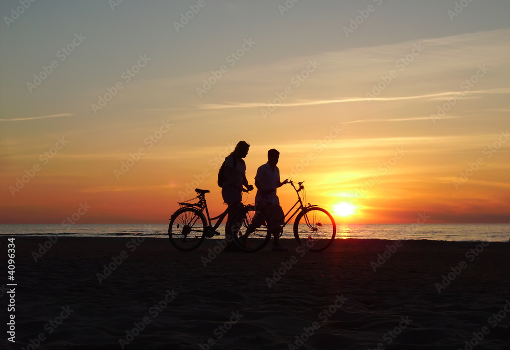 Two bicyclists on a beach