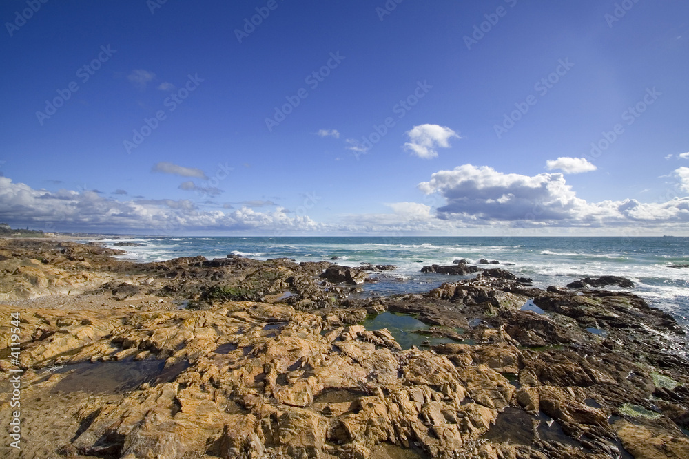 Seascape with rocks and deep blue sky