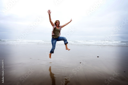 Happy Jumping Woman at the Beach