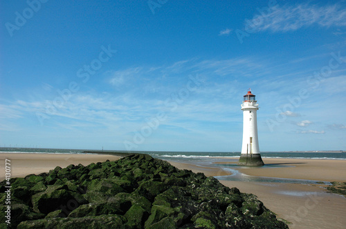 Blue sky lighthouse and rocks