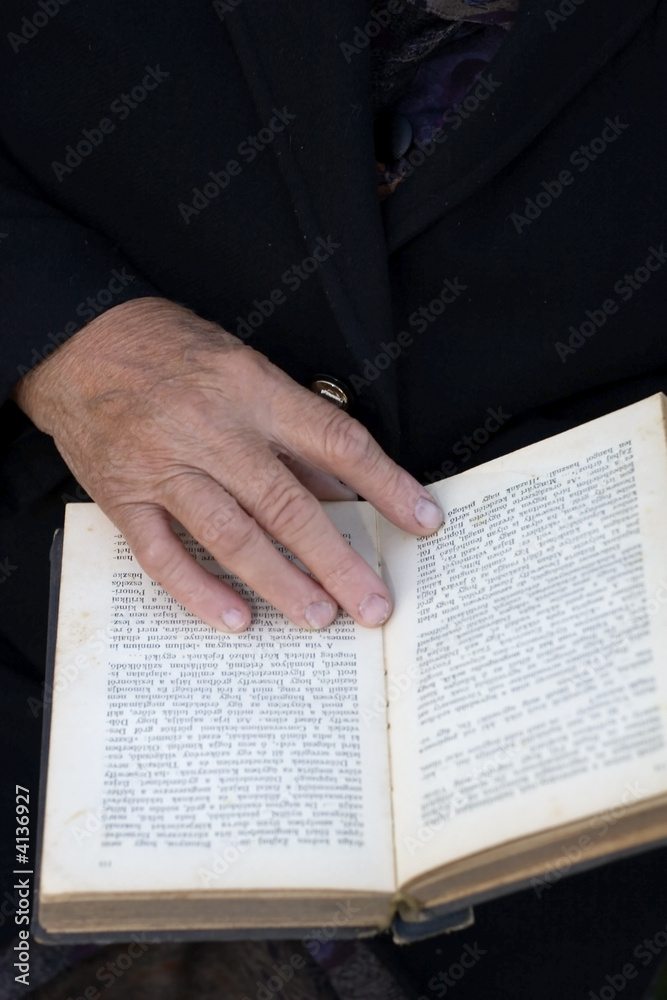 Senior's hands on old Bible Senior's hands on old Bible