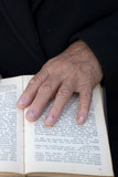 Senior's hands on old Bible