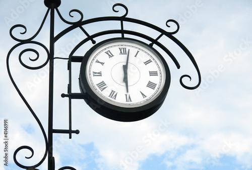 street clock on tha sky background photo