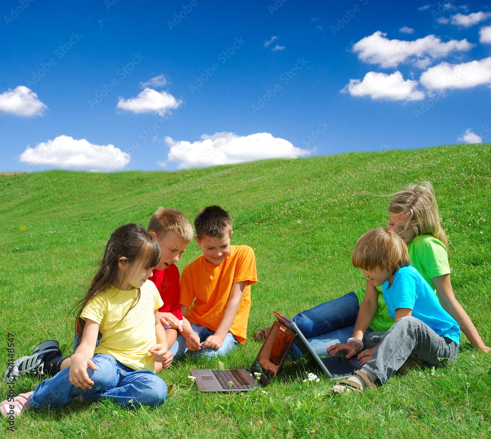 Kids in a Meadow with Laptops