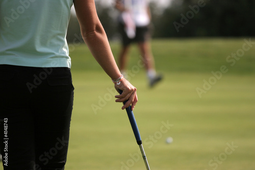 lady golf action on the putting green