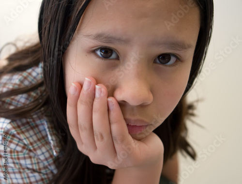schoolgirl resting head in hand