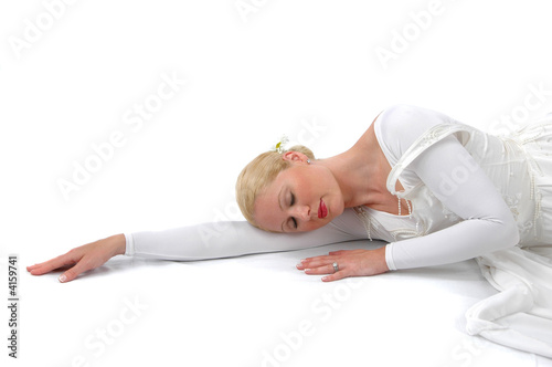 Ballerina resting on her arm on a white background