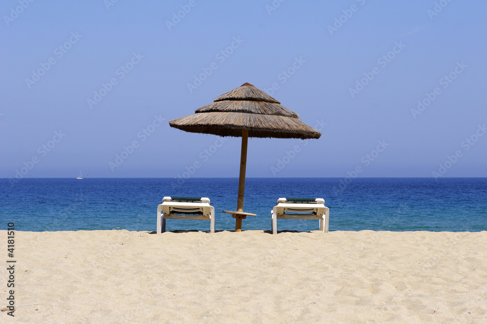Fototapeta premium sun lounger on sandy beach
