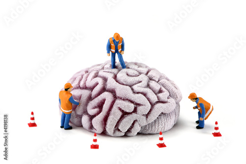 Brain with workers inspecting it. Mental Health concept photo