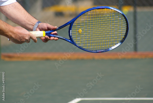Man holding a tennis racket © Elzbieta Sekowska