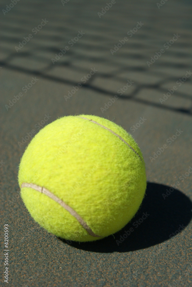 Tennis ball and the shadow of tennis net