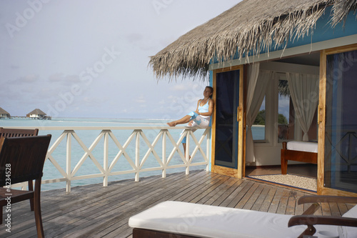Fototapeta Naklejka Na Ścianę i Meble -  young woman dreaming on tropical terrasse