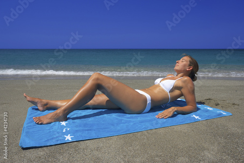 young woman tanning close