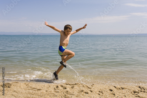 Child jump on the beach
