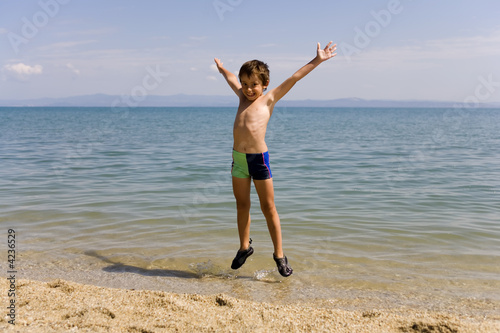 Child jump on the beach © Guy Shapira