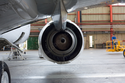 Jet engine at aircraft in the hangar, back view