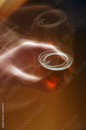 blurred hand holding a glass