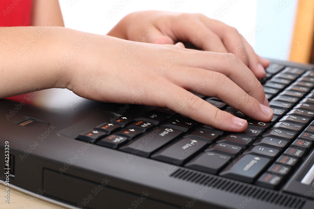 Hands typing on a laptop keyboard Hands typing on a laptop keyboard