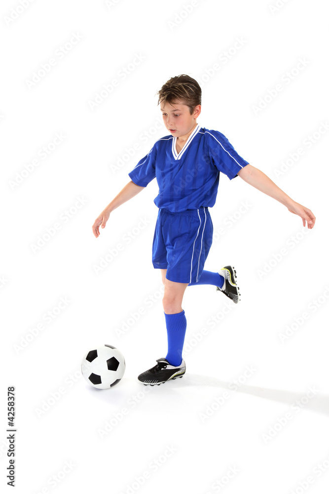 Youth kicking a soccer ball