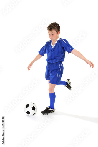 Youth kicking a soccer ball © Leah-Anne Thompson