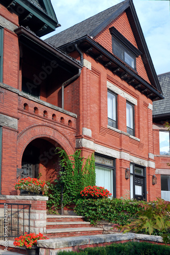 Victorian red brick house with ivy and arched entrance