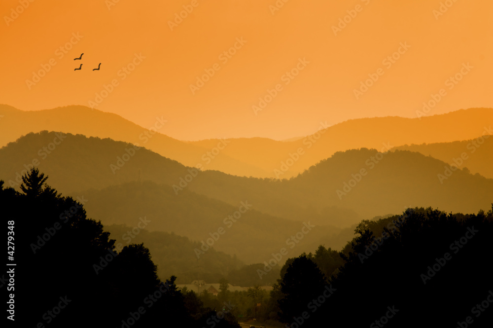 Serene sunrise over a distant mountain