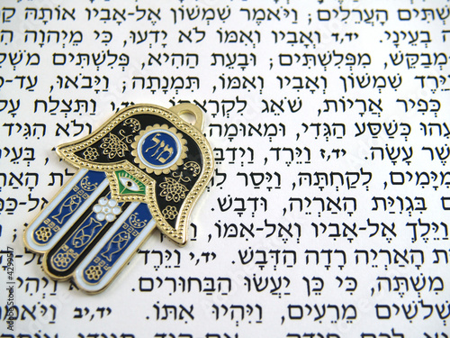Blue Hamsa kabala good luck charm on Hebrew bible
