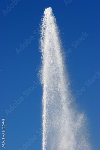 water geyser against a bright blue sky