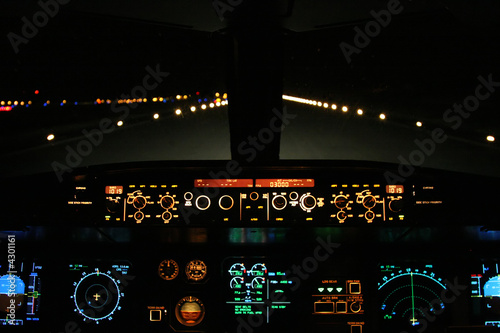 aircraft landing at night with runway ahead