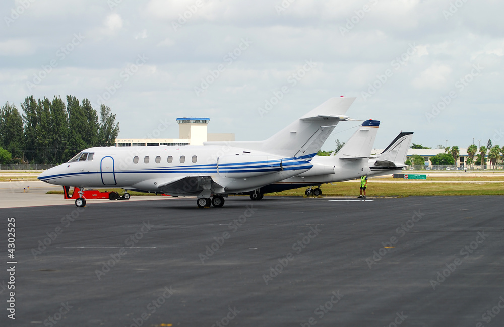 Corporate jet airplanes in a row Corporate jet airplanes in a row