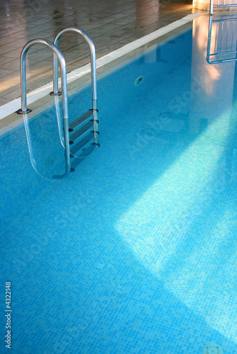 Indoor pool with a ladder and transparent water