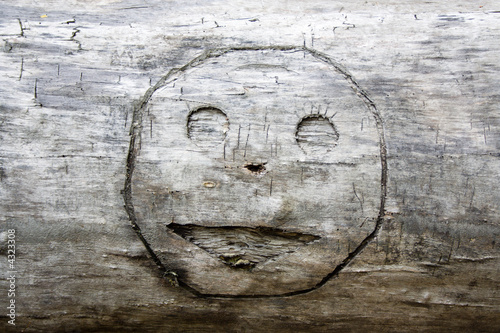 smile graven a long time ago in wood