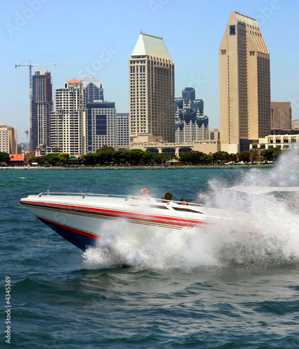 Racing boat in San Diego modern buildings