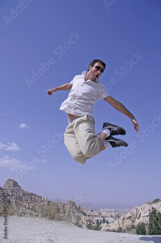 healthy happy man jumping in joy of life