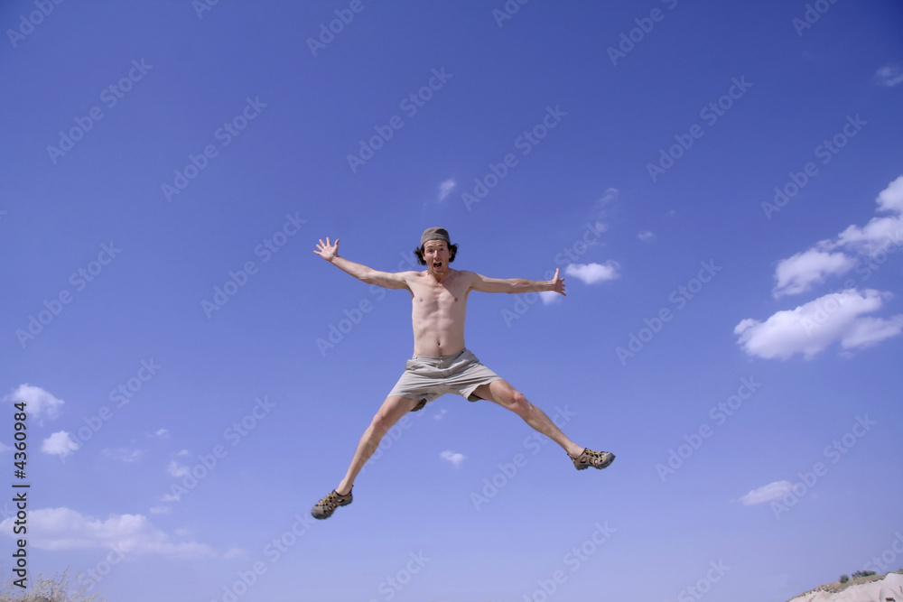 healthy happy man jumping in joy of life