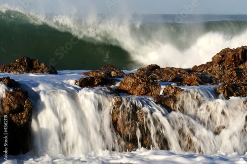 Large ocean waves crashing over rocks at the sea side