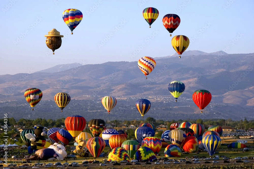 Fototapeta premium Hor air balloons taking off from the green field