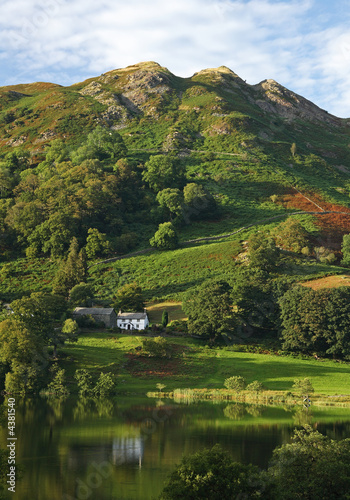 Farmhouse, lkae and mountains photo