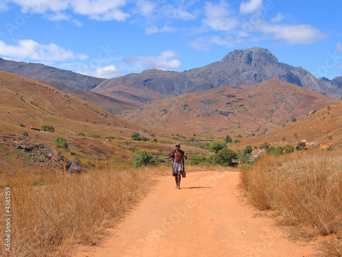 Man walking alone with nude feet on a dirty track,Madagascar