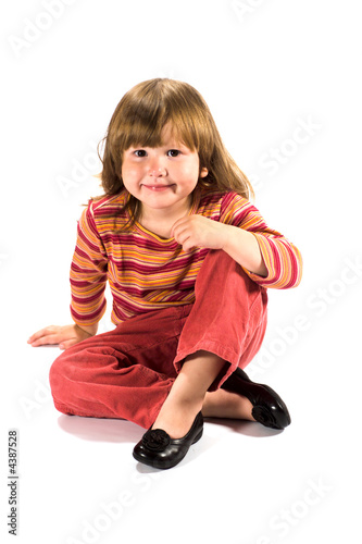 Happy kid sitting on the floor