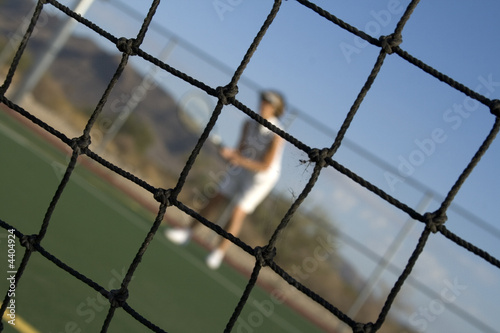 Tennis Player Through Net