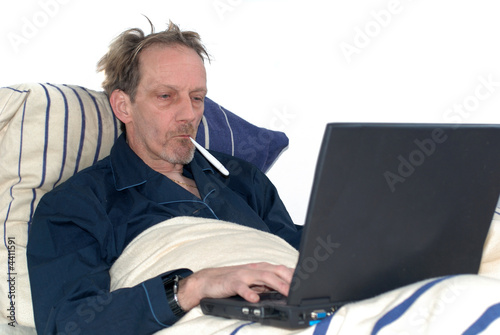 Tableau sur toile sick in bed with laptop.