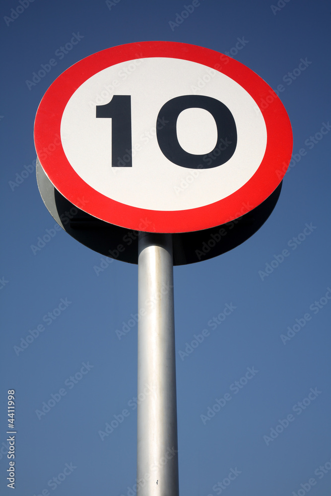 A British red and white round 10 miles an hour road sign. A British red and white round 10 miles an hour road sign.