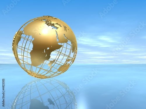 goldener globus   ber dem ozean