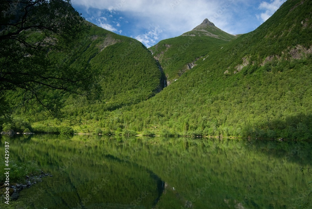 Lush green mountain with a lake