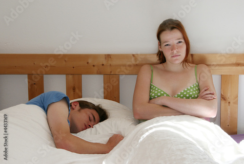 Man asleep, woman disappointed